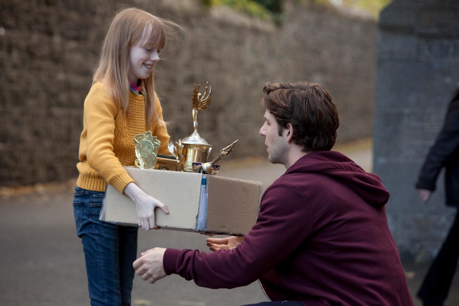 Jenny Rane gives Danny Dempsey a box of trophies. © RTÉ